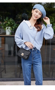 Chic black quilted crossbody bag with metal lock shown in a stylish outdoor outfit