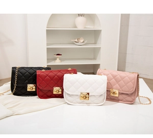 Detailed view of quilted PU leather cross-body bags with golden metal swivel locks