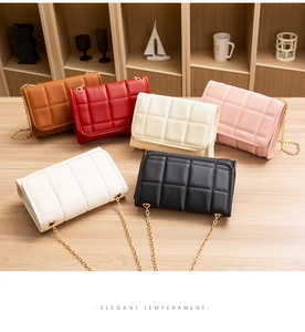 Multiple elegant quilted chain bags in various colors displayed on a wooden shelf