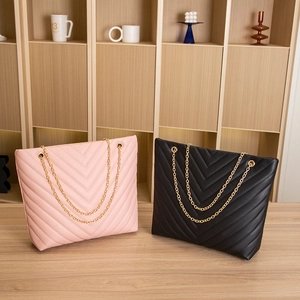 Quilted tote bags in pink and black featuring V-stitch patterns and gold chain straps