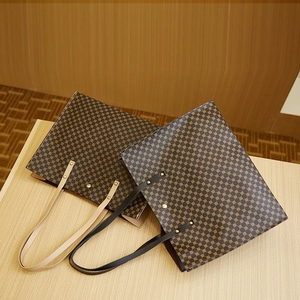 Vintage large capacity tote bag with dark brown geometric pattern on wooden background