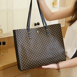 Detailed view of women's tote bag featuring vintage geometric patterns and leather handles