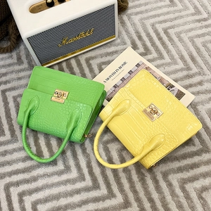 Green and yellow croc-embossed chain crossbody bags with gold metal square locks