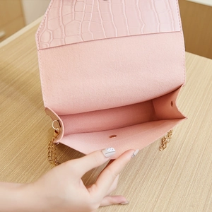 Light pink crocodile pattern crossbody bag with gold chain strap and magnetic closure