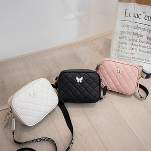 Minimalist quilted camera bags for women in white, black and pink with butterfly buckles