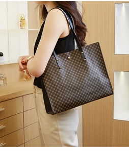 Spacious tote bag with geometric pattern and golden rivet details shown from a side view