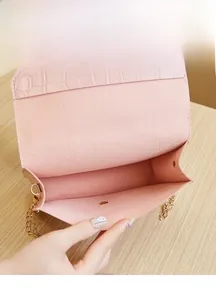 Detail view of pink crocodile-embossed bag interior showing spacious main compartment