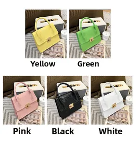 Detail view of small square bags in five colors with stone pattern and metal chain straps