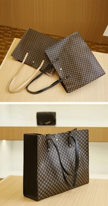 Detail view of large printed tote bag with retro geometric pattern and metallic rivets