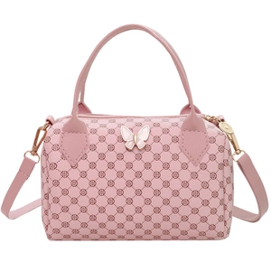 Pink Boston handbag with clover pattern and gold hardware on white background