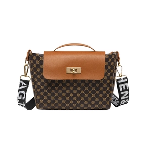 Vintage brown bucket bag with gold floral print and wide jacquard shoulder strap