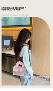 Detail view of pink quilted leather bag with fluffy handle and gold chain strap in a cafe