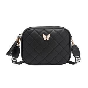 Black quilted crossbody camera bag with butterfly ornament and wide woven strap
