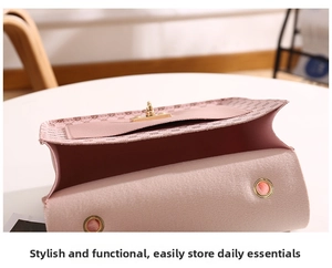 Detail view of the pink leather bag interior and golden metallic clasp closure
