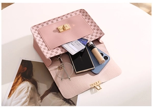 Pink crossbody bag detail showing spacious interior with phone, glasses and makeup