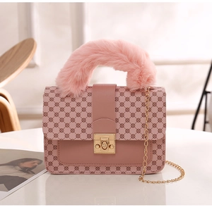 Close-up of pink floral leather handbag with faux fur handle and gold metal lock