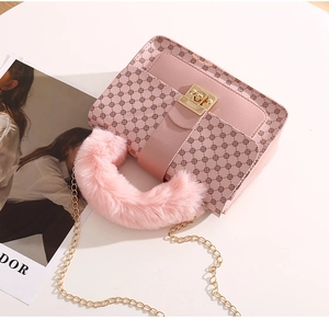 Detailed view of pink monogram crossbody bag with faux fur handle and gold chain strap