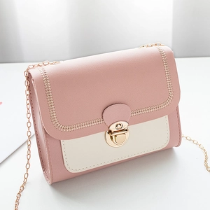Pink and beige colorblock crossbody bag with gold chain strap and metal lock closure