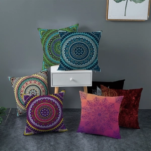 Boho Mandala throw pillow covers in vibrant patterns on a minimalist white side table