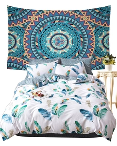 Detailed view of bohemian mandala tapestry wall hanging behind feather print bedding set