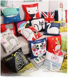 Detailed pile of assorted square throw pillows with cute animal illustrations on a beige sofa