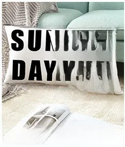 Detail of black short plush pillow featuring Sun Day and Good Morning gold foil print