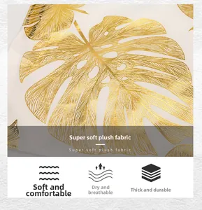 Detail of plush black pillow with gold leaf stamping showing soft texture and leaf pattern