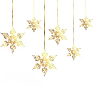 Detail of hanging gold snowflake ornaments with hollow floral and heart pattern
