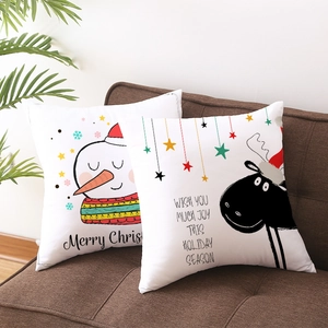 Set of 2 Christmas peach skin pillow covers featuring snowman and reindeer on sofa