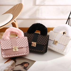Three geometric print handbags with faux fur handles in pink, brown, and white colors