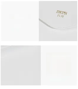 Detail of white leather bag featuring a gold JINGPIN PI JU logo and precise stitching