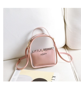 Detail of pink transparent PVC crossbody bag showing inner pouch and Little Beauty print