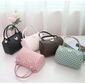 Boston handbags displayed in five colors with retro patterns and butterfly gold hardware