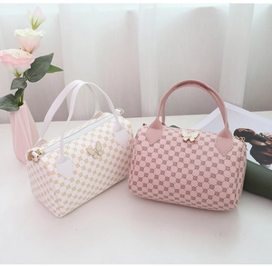 Close-up of pink and white mini Boston bags featuring butterfly metal clasps and prints