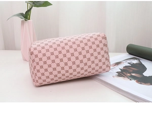 Detail of light pink cylindrical bag with floral pattern and lychee texture