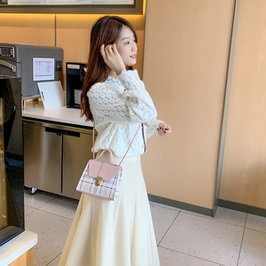 Pink flap and plaid pattern crossbody mini bag with metal lock shown on a model