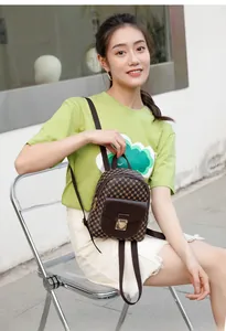 Mini brown checkered backpack for women with a gold shield-shaped metal lock buckle