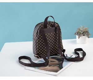 Detail view of mini vintage backpack with geometric pattern and adjustable woven strap