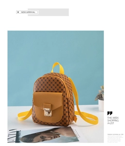 Detail of printed mini backpack featuring a metal twist lock and yellow nylon strap