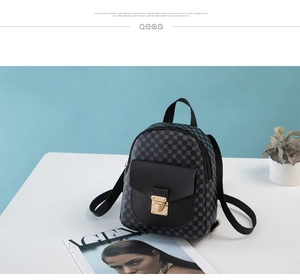 Detail of mini backpack featuring geometric print fabric and black leather front pocket