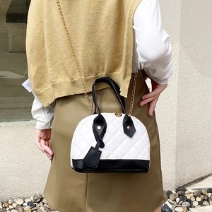 Quilted diamond lattice handbag with gold chain strap and black and white contrast trim