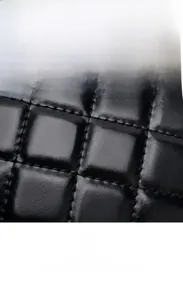 Close-up of black quilted leather material with durable scratch-resistant diamond texture