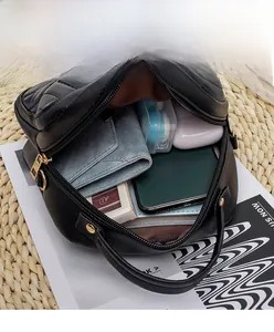 Internal view of the black quilted crossbody bag showing large capacity for essentials