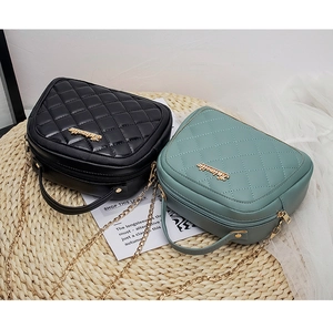 Top view of quilted PU leather bags in black and green with gold chain and metal hardware