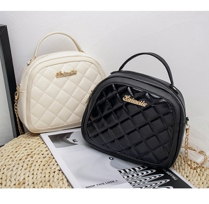 Detail of crossbody mini bags with quilted patterns, gold chains and brand logo
