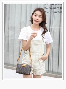Detailed close-up of brown cross-body bag with VIFN letter pattern and yellow leather buckle