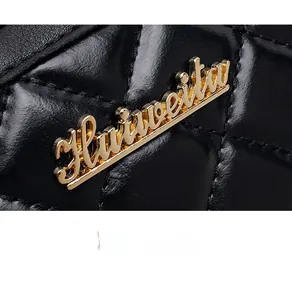 Close-up of black quilted leather texture and golden metal Huiweitu logo on bag