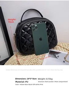 Quilted shell bag in black PU leather shown with smartphone for size comparison