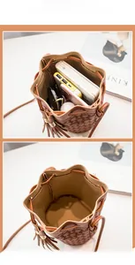 Detail view of large capacity brown embossed bucket bag with drawstring and dual tassels