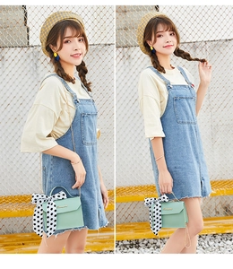 Mint green crossbody bag with polka dot scarf and metal chain on a casual denim outfit